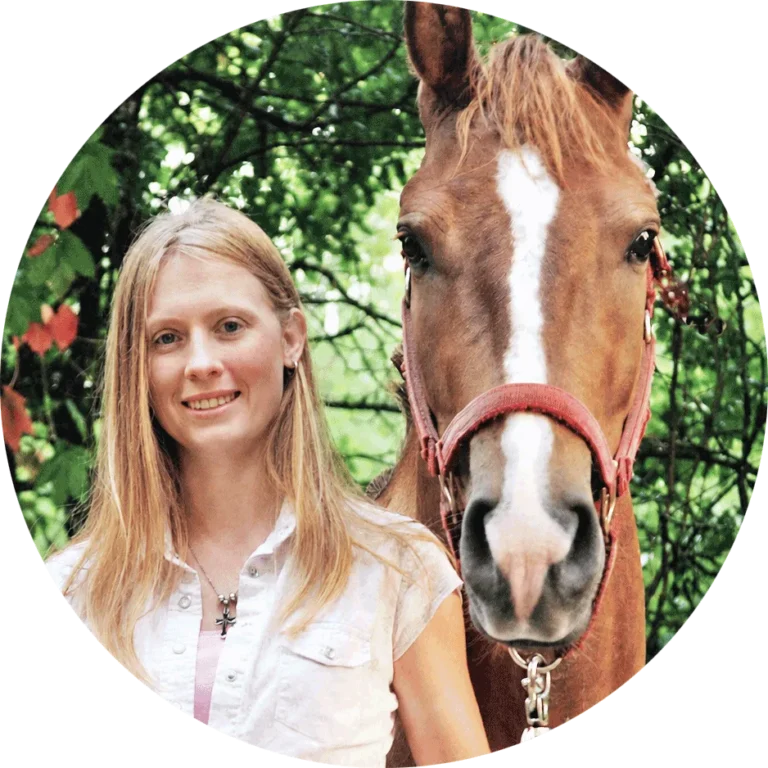 CharlieAnn Green smiling beside a chestnut horse
